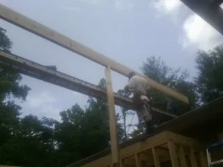 Carpenter setting a ridge beam over a new addition frame — Ice Dam Removal by Roofing Brothers in Chambersburg