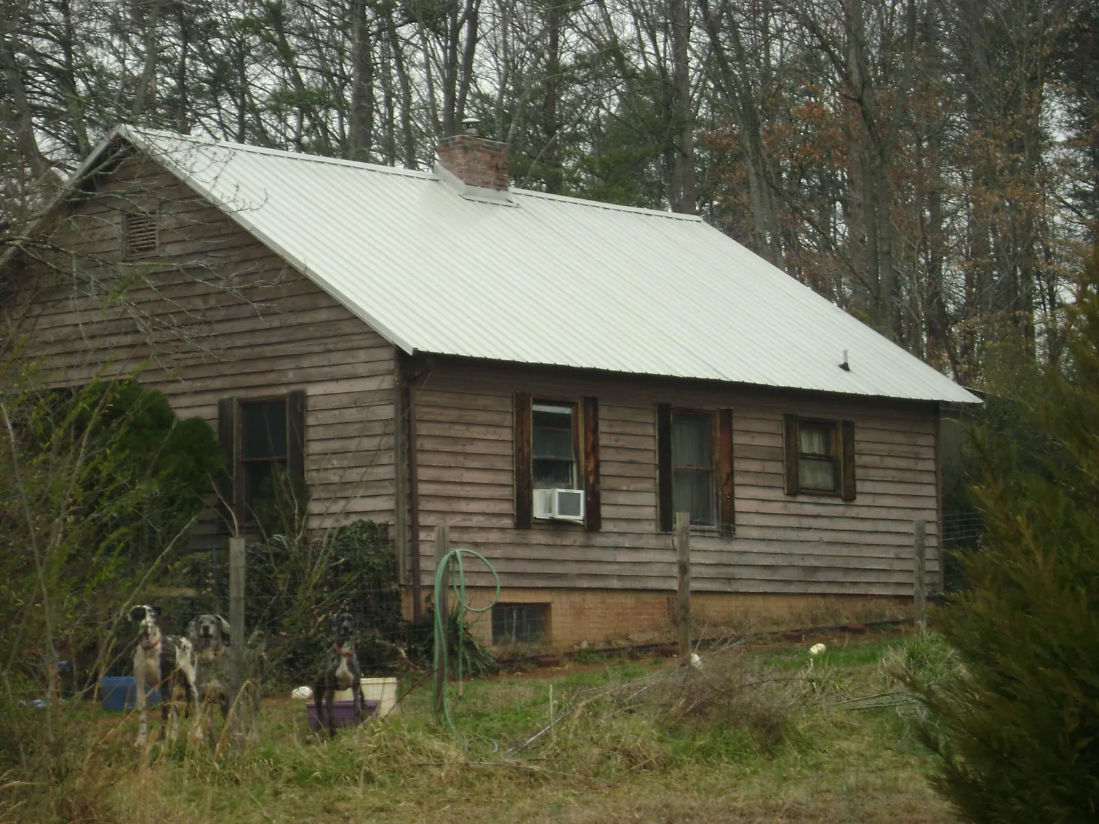 White metal roof on an old wood sided farmhouse, from a Asphalt Shingle Roof Repair job in Chambersburg